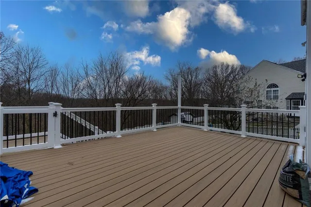 a view of a balcony with wooden floor and fence