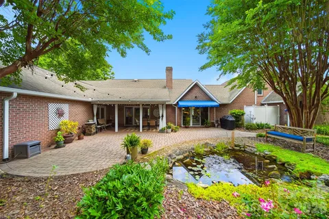 a front view of a house with a yard and outdoor seating