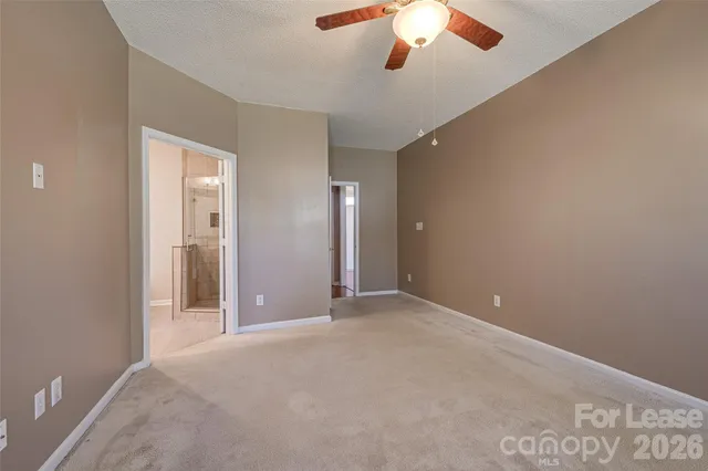 an empty room with chandelier fan