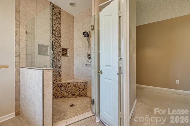 a bathroom with a glass door shower