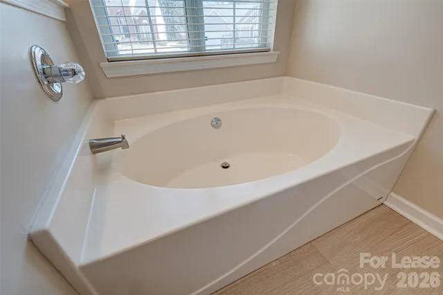 a white bath tub sitting next to a window