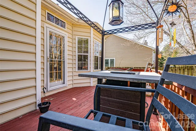 a view of a yard with wooden fence