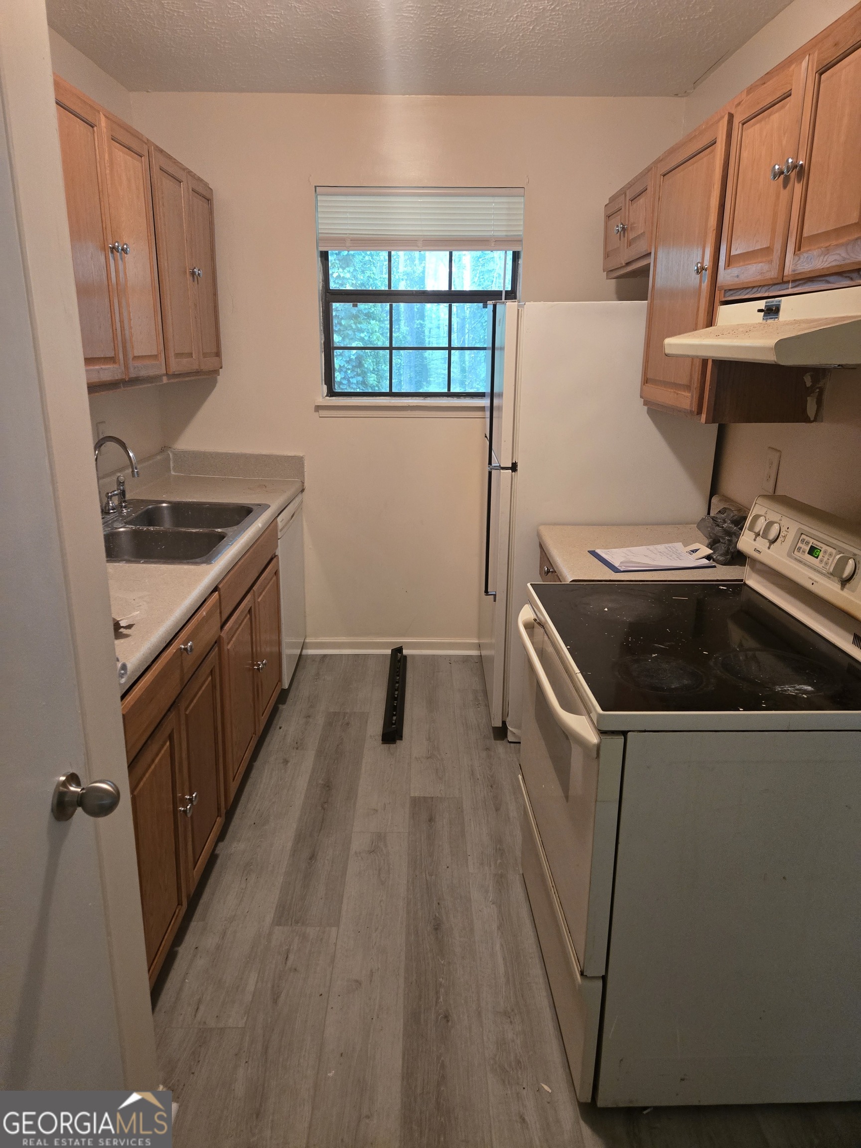 4749 Big Valley Road Stone Mountain, GA 30083 - Photo 2 of 7 a kitchen that has a sink and wooden floor