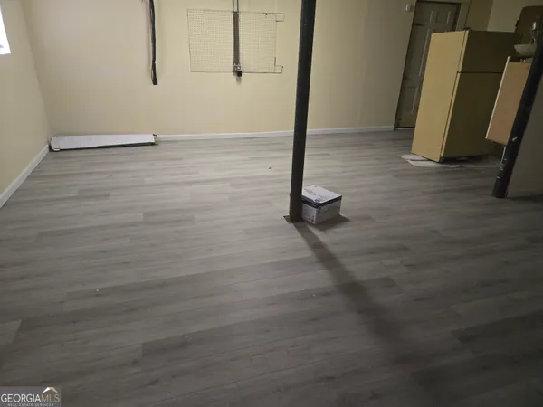 a view of a room with wooden floor