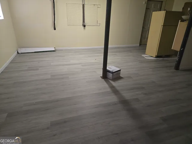 a view of a room with wooden floor