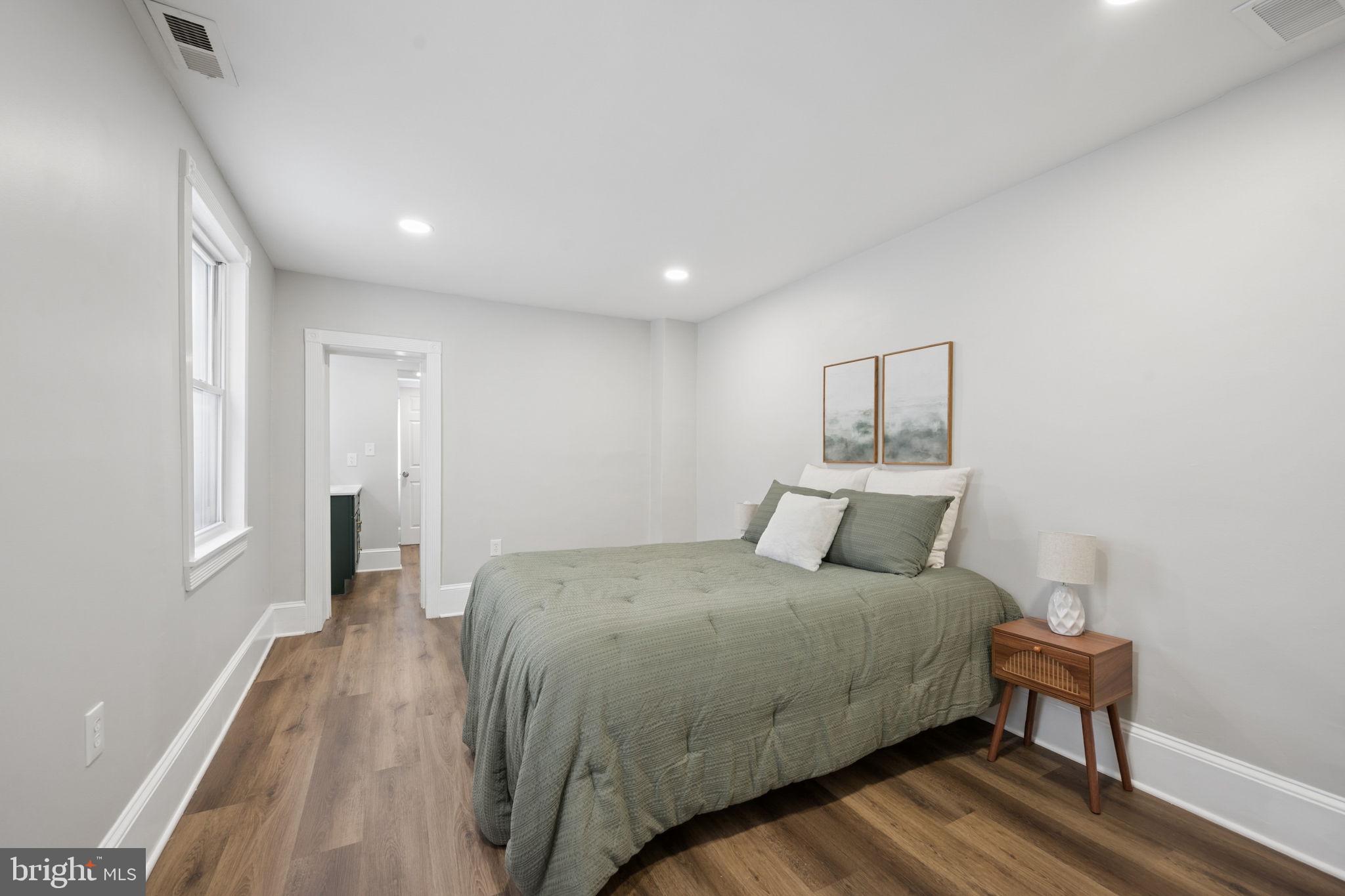 1108 South Clinton Street Baltimore, MD 21224 - Photo 37 of 66 Serene bedroom with modern elegance.