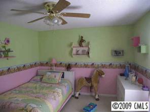 5946 Stokes Ferry Road Salisbury, NC 28146 - Photo 8 of 8 a bedroom with a bed and a chandelier
