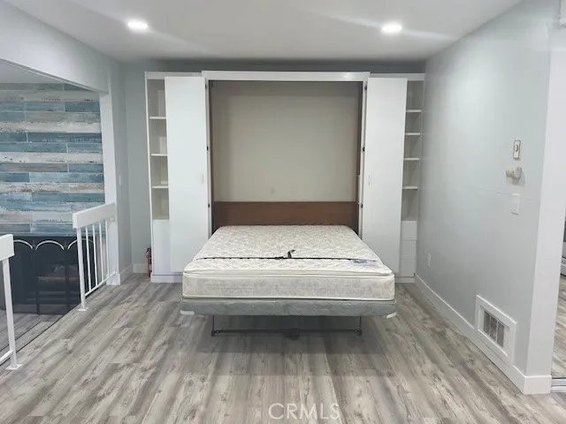 a view of a livingroom with wooden floor and a fireplace