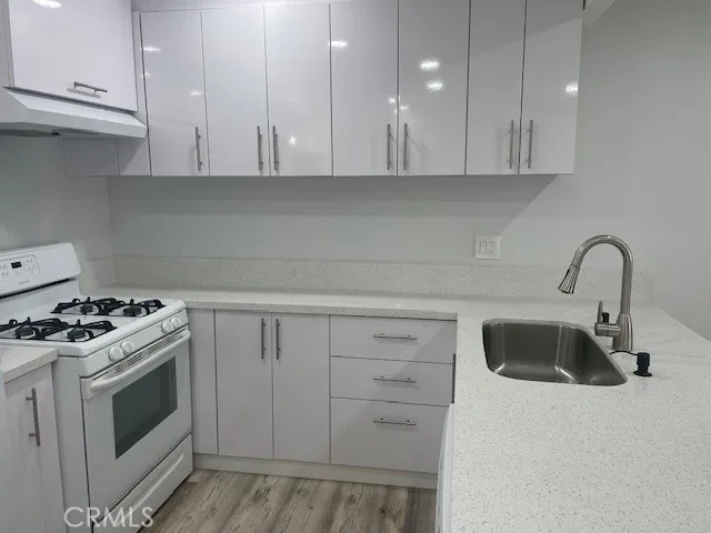 a kitchen with white cabinets and white appliances