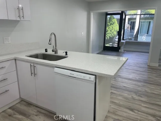 a view of a kitchen with fridge and front door