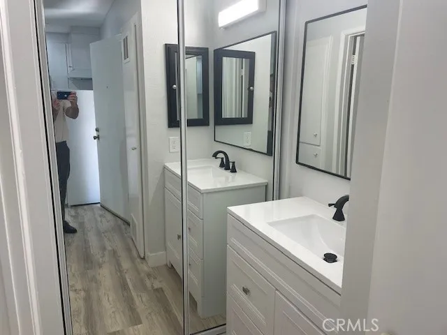 a bathroom with a sink a mirror and shower