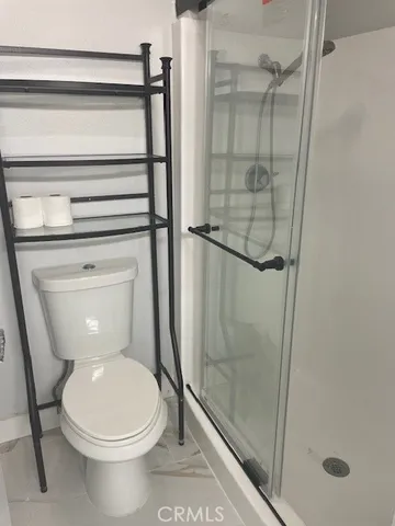 a bathroom with a toilet and a shower