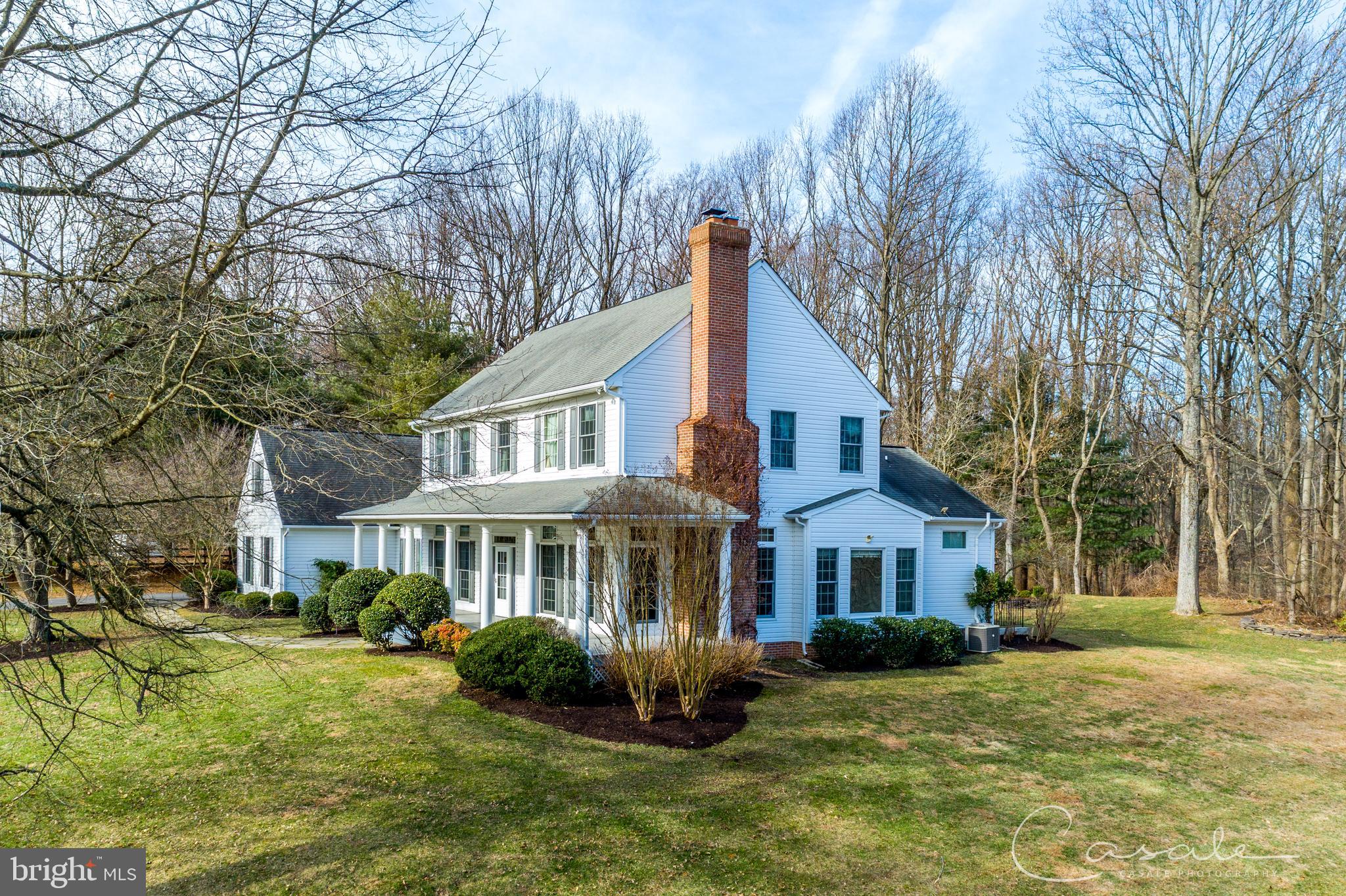 a front view of a house with yard and green space