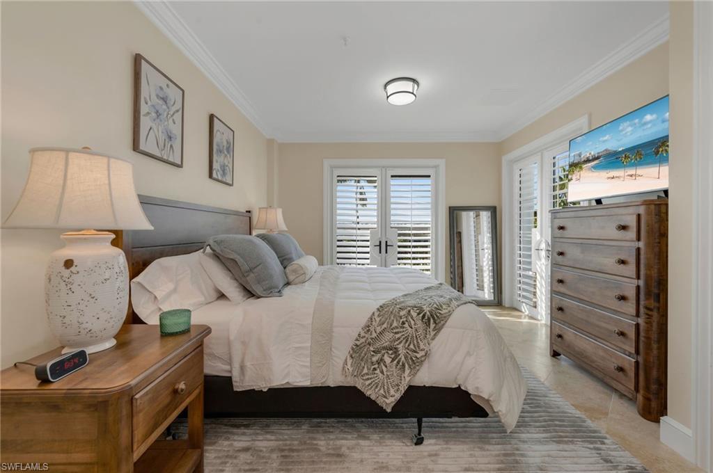780 5th Avenue South, Unit 302 Naples, FL 34102 - Photo 11 of 20 a bedroom with a bed and closet