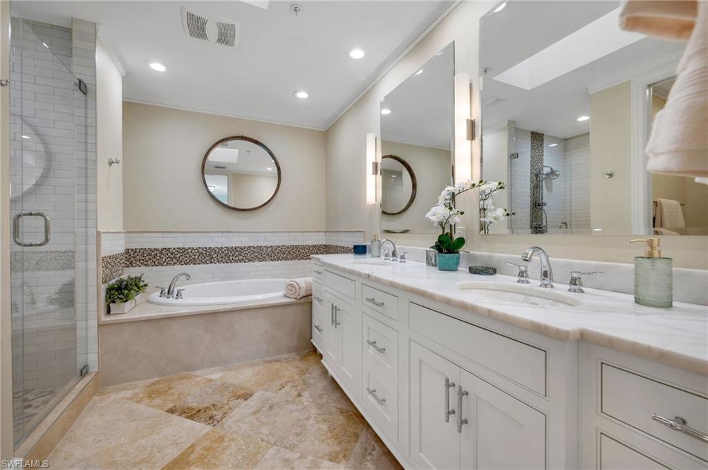 780 5th Avenue South, Unit 302 Naples, FL 34102 - Photo 12 of 20 a bathroom with a tub a sink double vanity and a mirror
