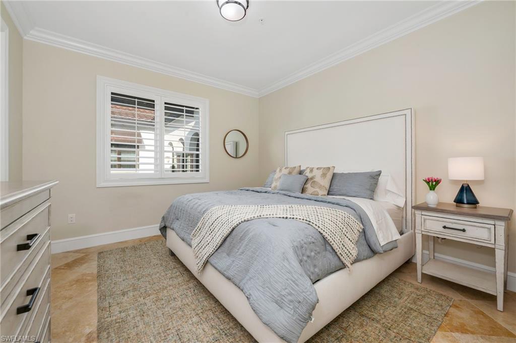 780 5th Avenue South, Unit 302 Naples, FL 34102 - Photo 13 of 20 a bedroom with a bed and a window