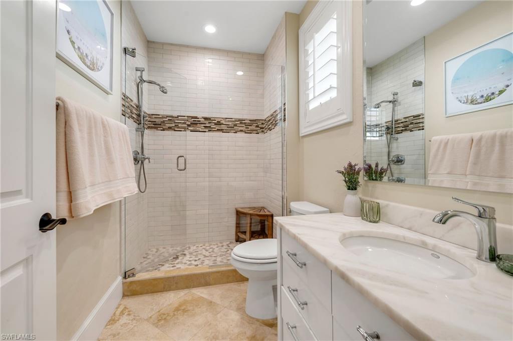 780 5th Avenue South, Unit 302 Naples, FL 34102 - Photo 14 of 20 a bathroom with a sink a toilet and shower