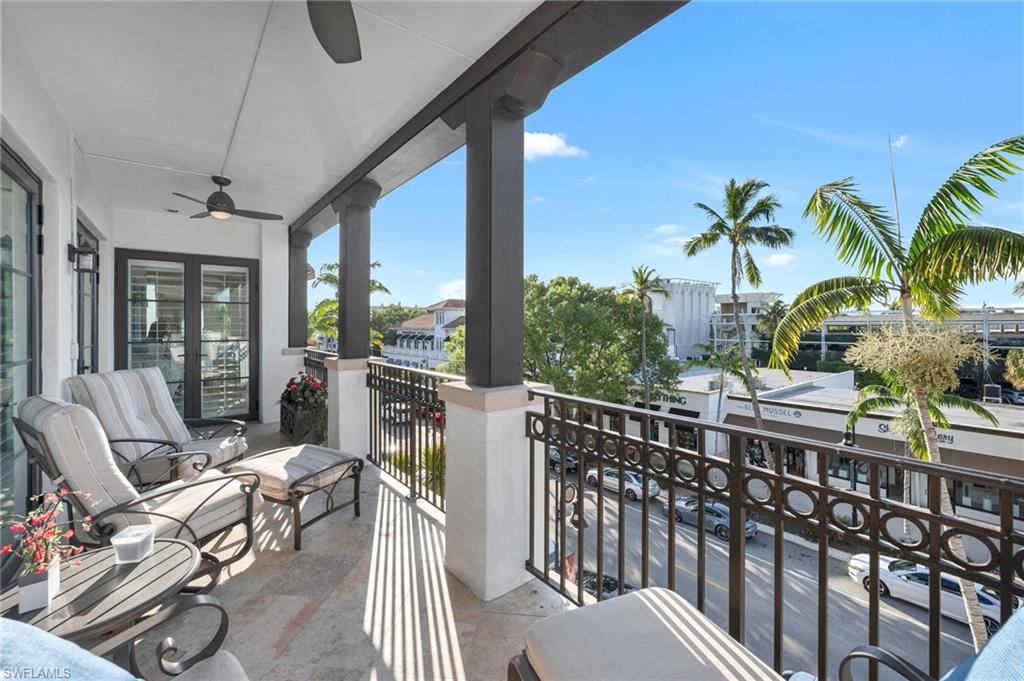 780 5th Avenue South, Unit 302 Naples, FL 34102 - Photo 15 of 20 a view of a balcony with chairs and table