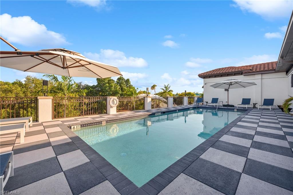 780 5th Avenue South, Unit 302 Naples, FL 34102 - Photo 18 of 20 a view of a swimming pool with a lounge chairs