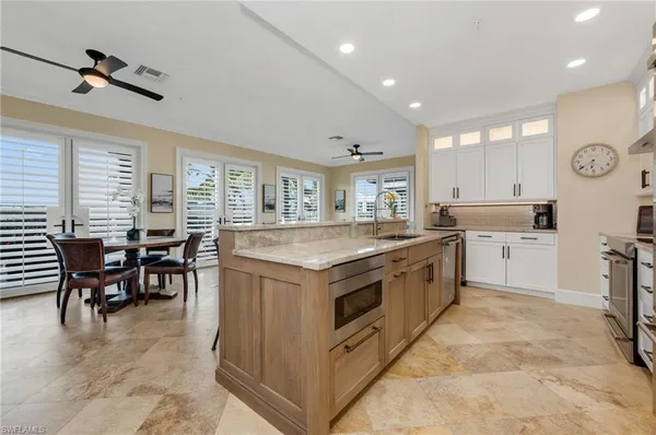 a kitchen with cabinets and chairs