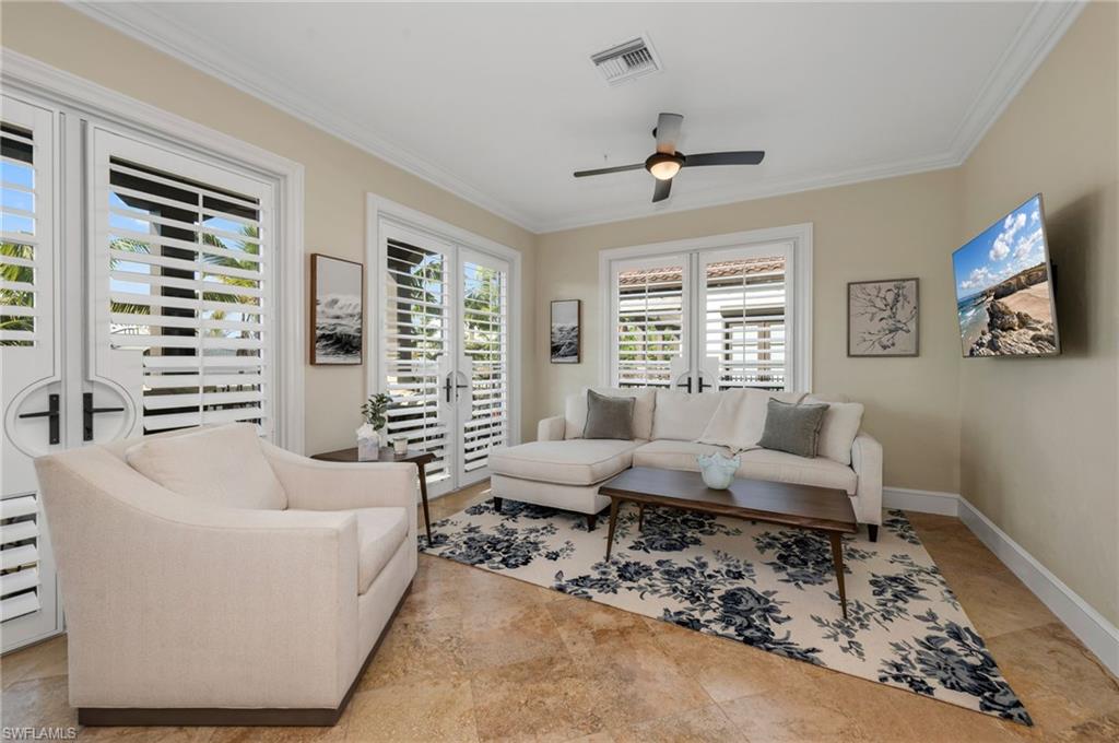 780 5th Avenue South, Unit 302 Naples, FL 34102 - Photo 9 of 20 a living room with furniture and a large window
