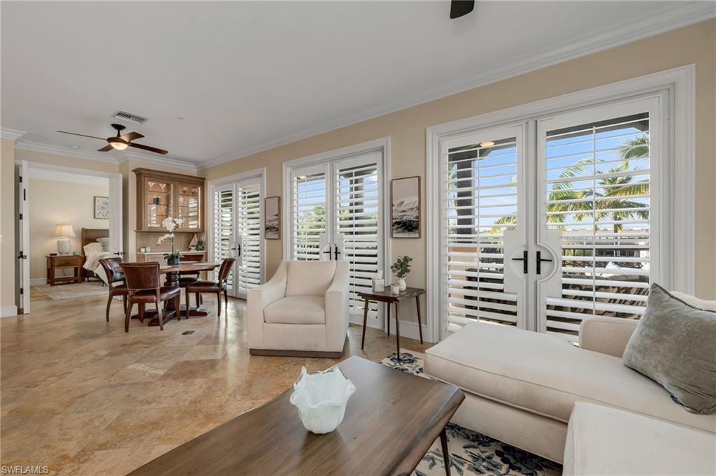 780 5th Avenue South, Unit 302 Naples, FL 34102 - Photo 10 of 20 a living room with furniture and wooden floor