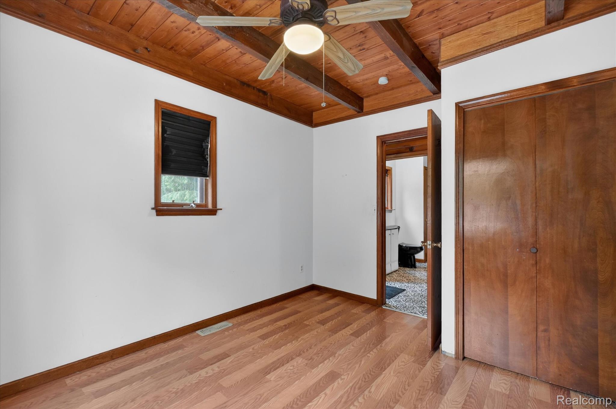 41303 Harris Road Belleville, MI 48111 - Photo 37 of 49 Unfurnished bedroom featuring light wood finished floors, a wooden ceiling with exposed beams, ceiling fan, and a closet