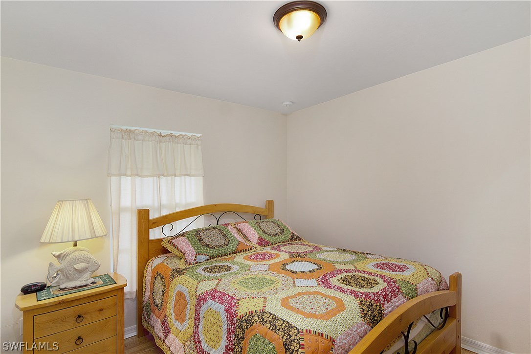 3002 52nd Street West Lehigh Acres, FL 33971 - Photo 14 of 18 a bedroom with a bed and a window
