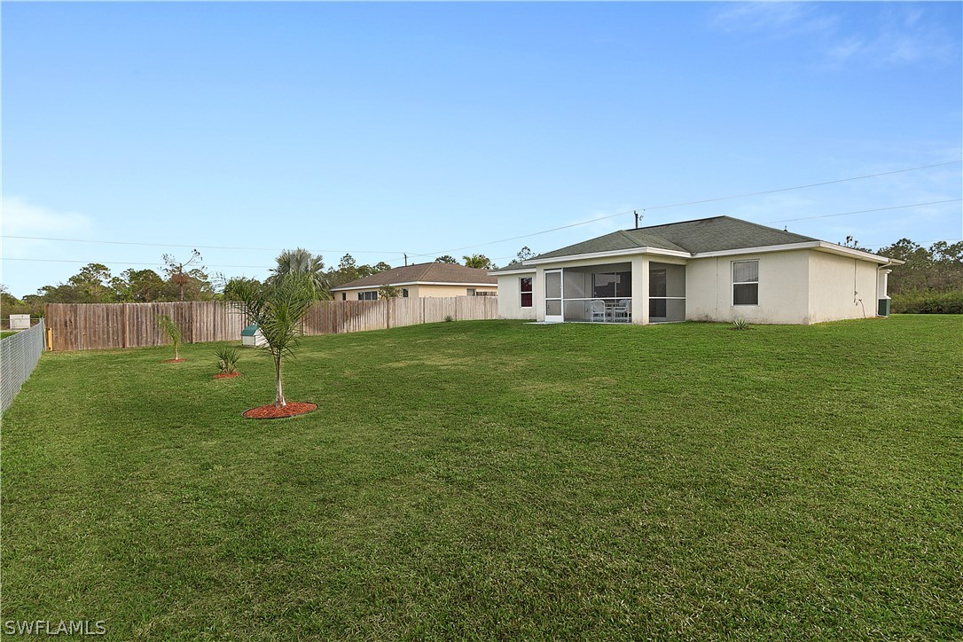 3002 52nd Street West Lehigh Acres, FL 33971 - Photo 16 of 18 a big house with a big yard and large trees