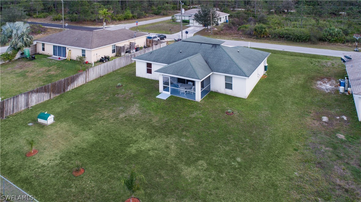 3002 52nd Street West Lehigh Acres, FL 33971 - Photo 17 of 18 an aerial view of residential houses with outdoor space and trees