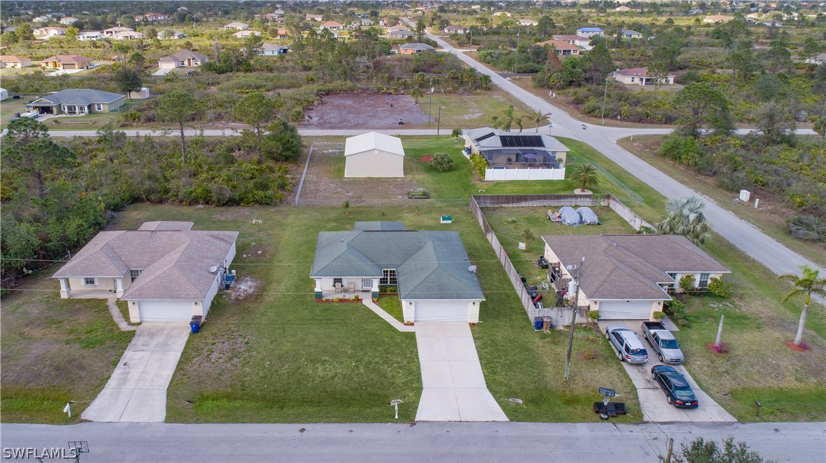 3002 52nd Street West Lehigh Acres, FL 33971 - Photo 18 of 18 an aerial view of a house with a garden