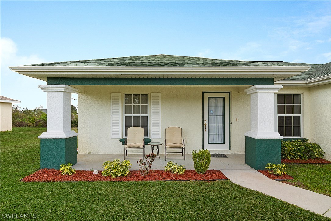 3002 52nd Street West Lehigh Acres, FL 33971 - Photo 2 of 18 a front view of a house with garden