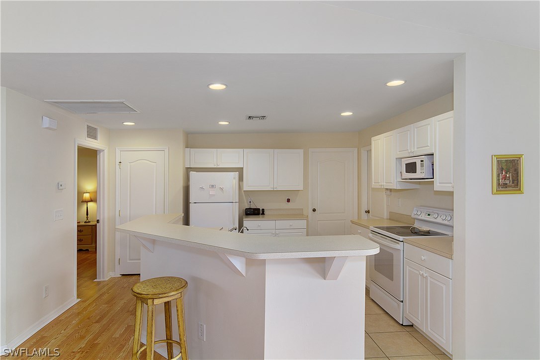 3002 52nd Street West Lehigh Acres, FL 33971 - Photo 7 of 18 a kitchen with stainless steel appliances granite countertop a sink and cabinets