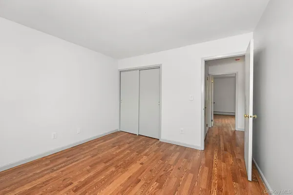 a view of a room with wooden floor and bench