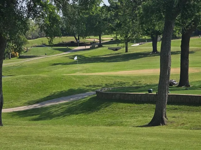 a view of swimming pool with a garden and trees