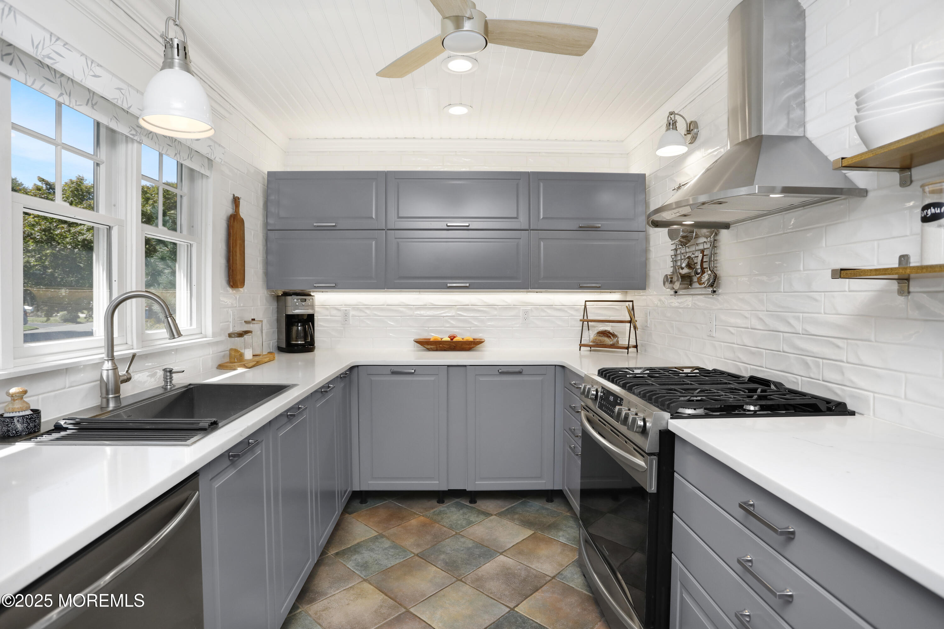 1706 Forest Street Wall, NJ 07719 - Photo 17 of 61 a kitchen with a sink a stove and cabinets