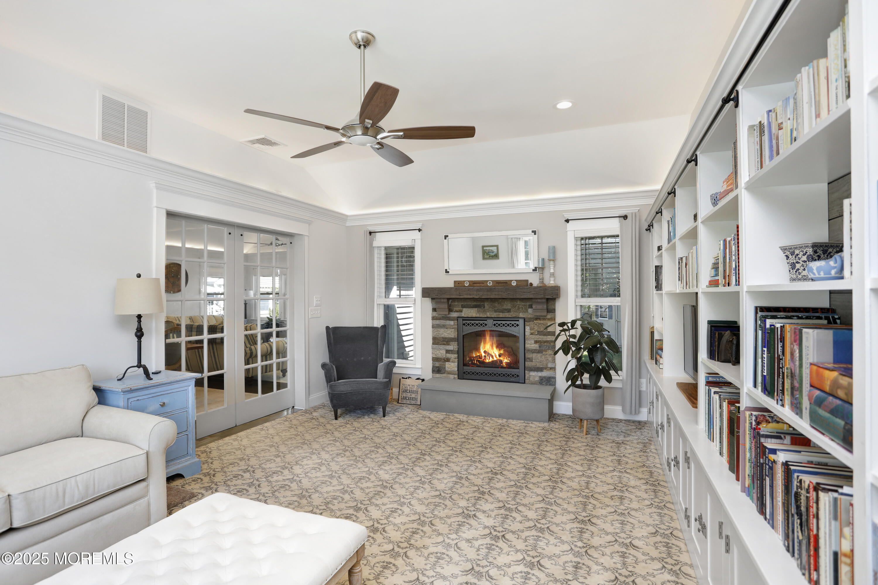1706 Forest Street Wall, NJ 07719 - Photo 23 of 61 a living room with furniture a fireplace and a book shelf