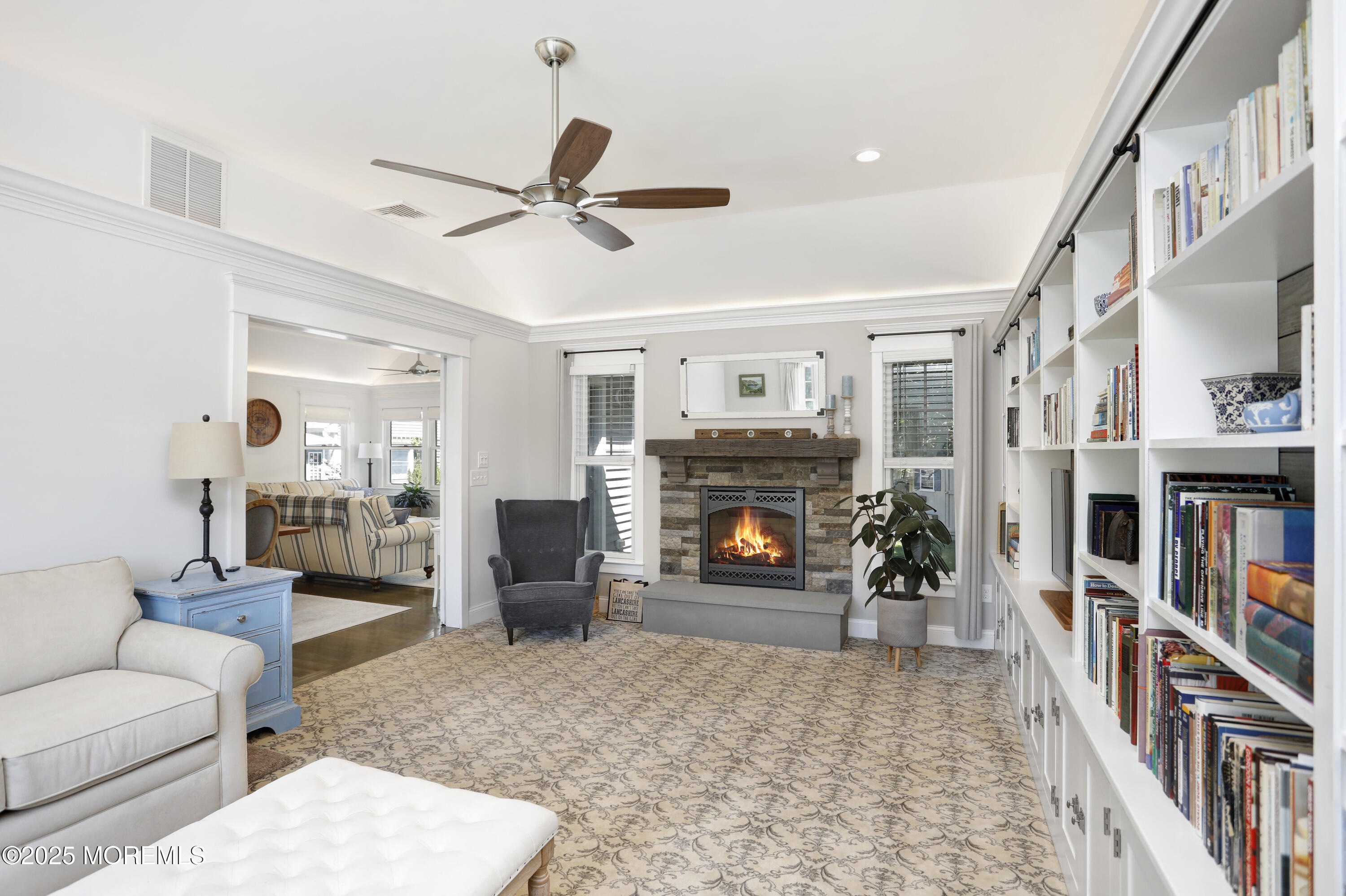 1706 Forest Street Wall, NJ 07719 - Photo 24 of 61 a living room with furniture a fireplace and a book shelf