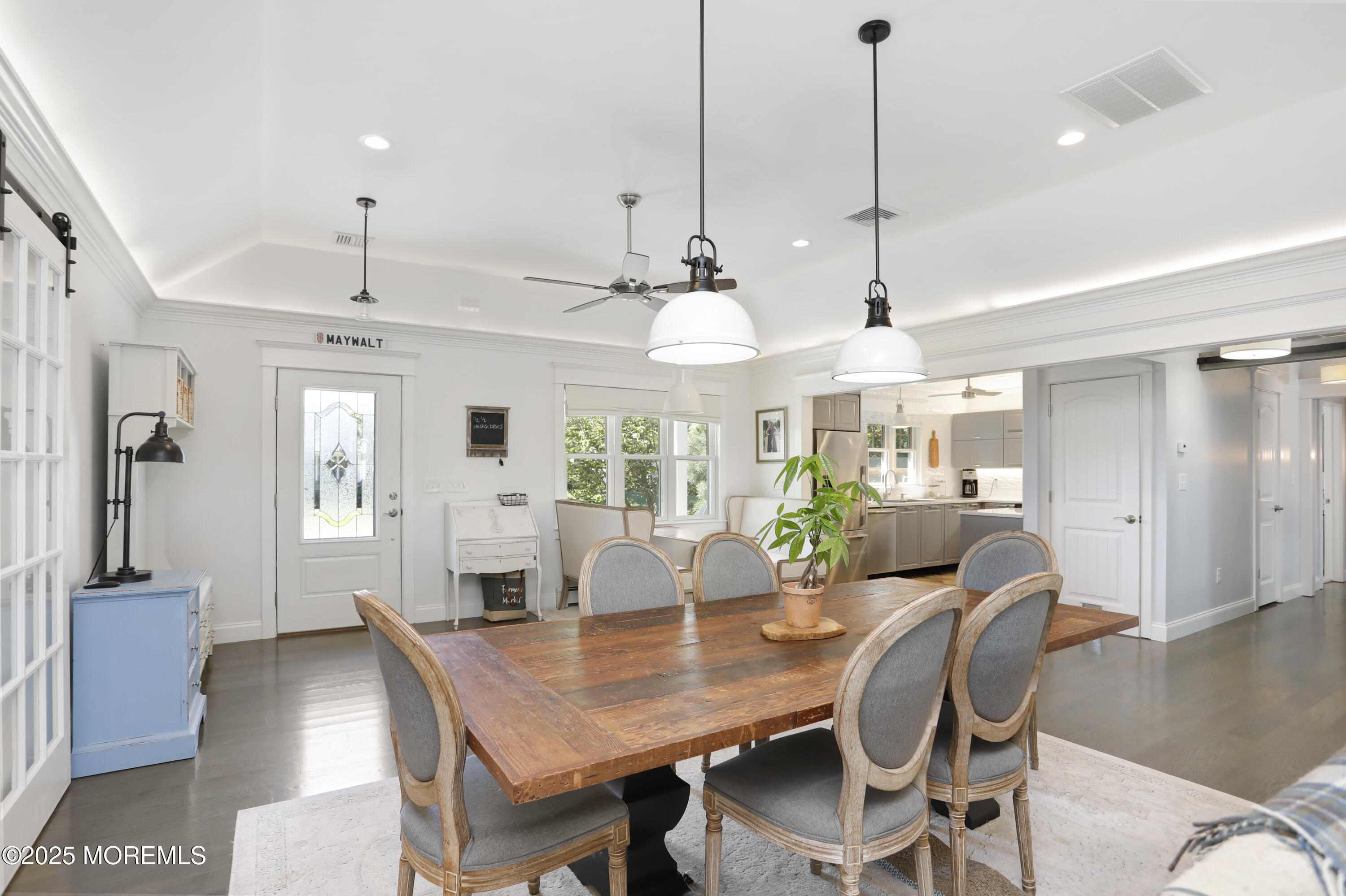 1706 Forest Street Wall, NJ 07719 - Photo 7 of 61 a dining room with furniture a chandelier and wooden floor