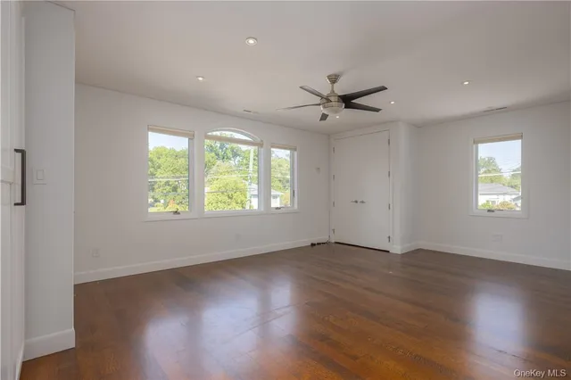 a bathroom with a bathtub shower sink vanity and toilet