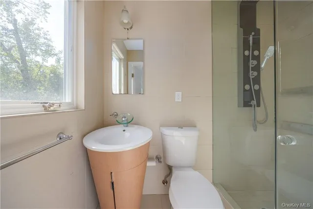 an empty room with ceiling fan and windows