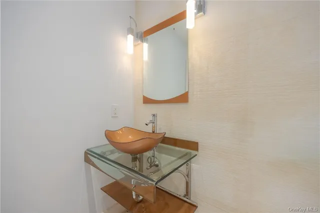 a kitchen with stainless steel appliances granite countertop a refrigerator a sink a stove and a refrigerator