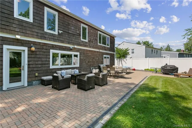 a view of a patio with couches chairs and potted plants