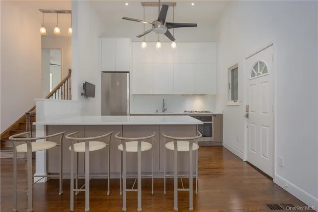 a kitchen with a sink cabinets and stainless steel appliances