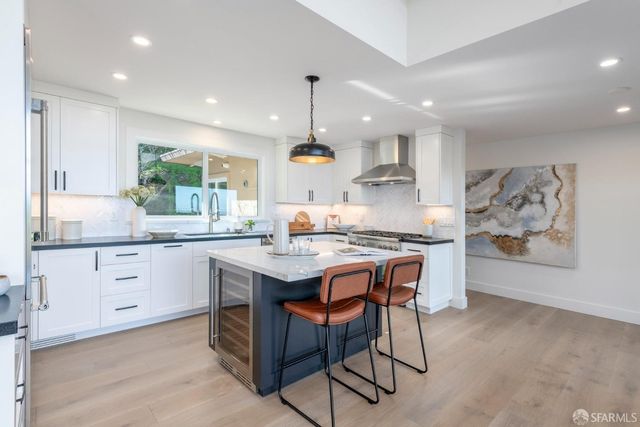 a kitchen with a stove and a cabinet with wooden floor