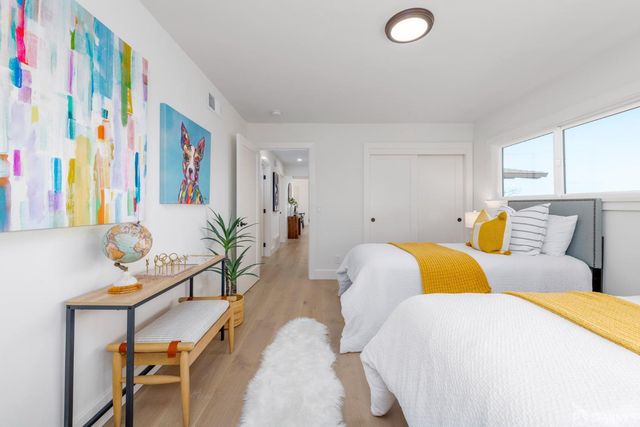 a bedroom with a bed and glass door