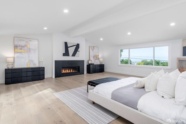 a bathroom with a tub sink shower and mirror