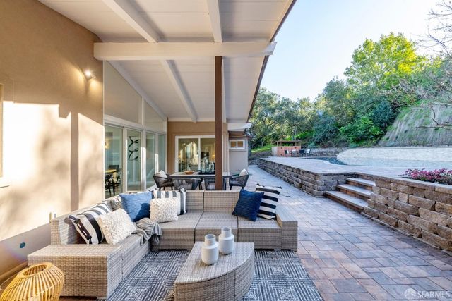 a lobby with furniture and a chandelier