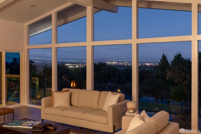 a view of a balcony with couches and a potted plant