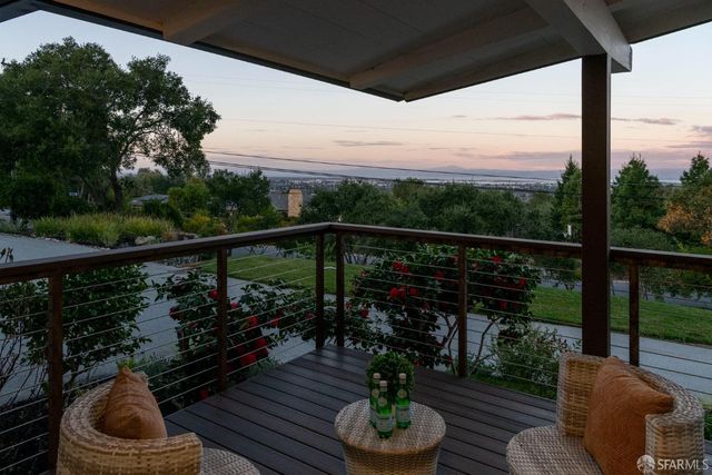 a view of a balcony with wooden floor and outdoor seating